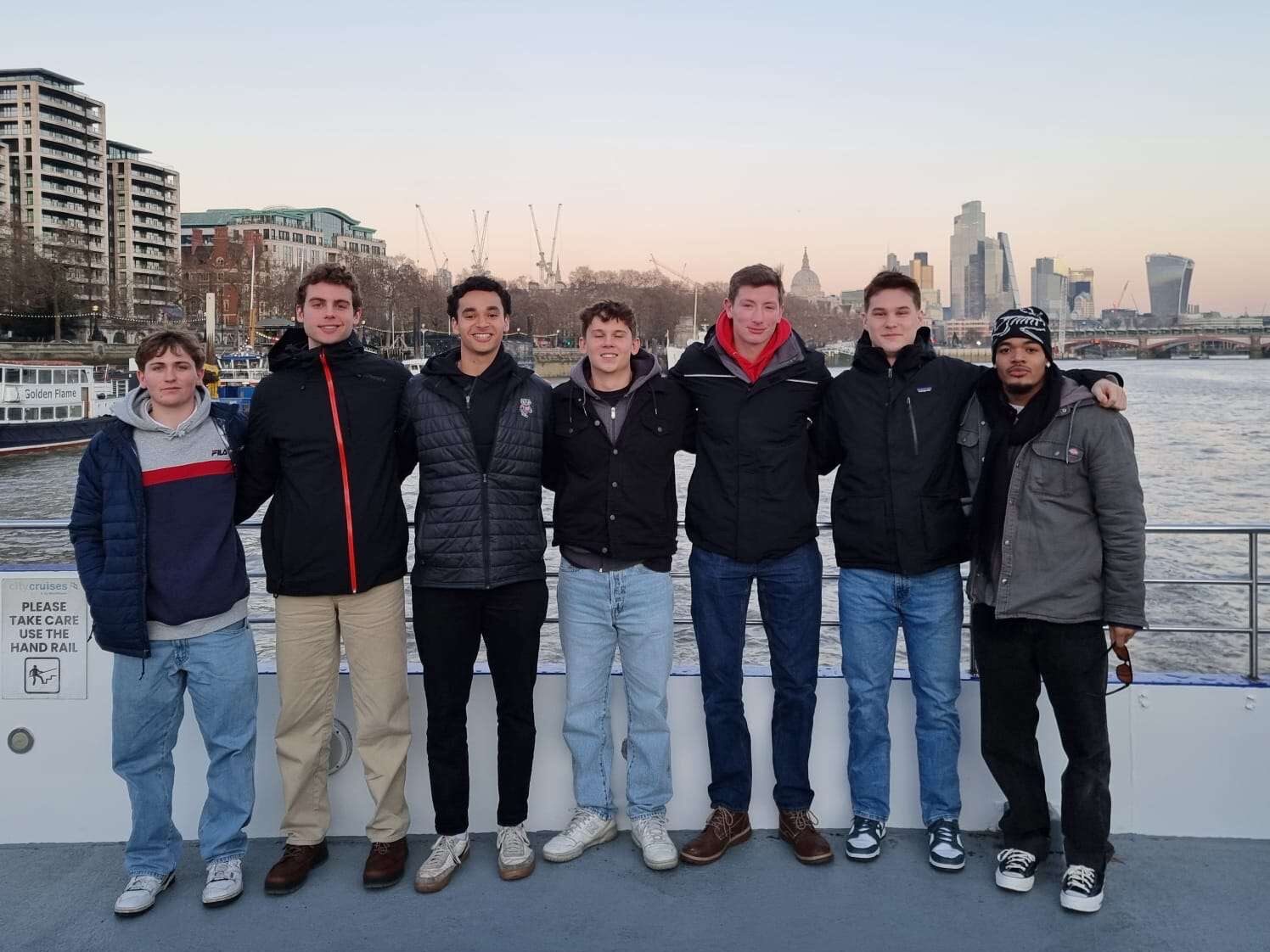 A group of students on a boat on the River Thames.